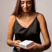 Thumbnail for Woman unboxing the Double Heart Photo Necklace by Brother & Sisters, showcasing excitement and love.