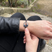 Thumbnail for Warming the black octagon photo bracelet with a thumb, her father's photo appears | SKU: TPH-OCTB-BLACK-18