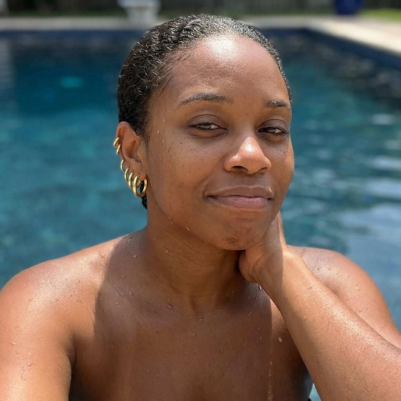 Huggie Hoop Earrings Set of 4 Pairs in Gold worn in a swimming pool, waterproof 304L stainless steel | SKU: huggie-set-gold