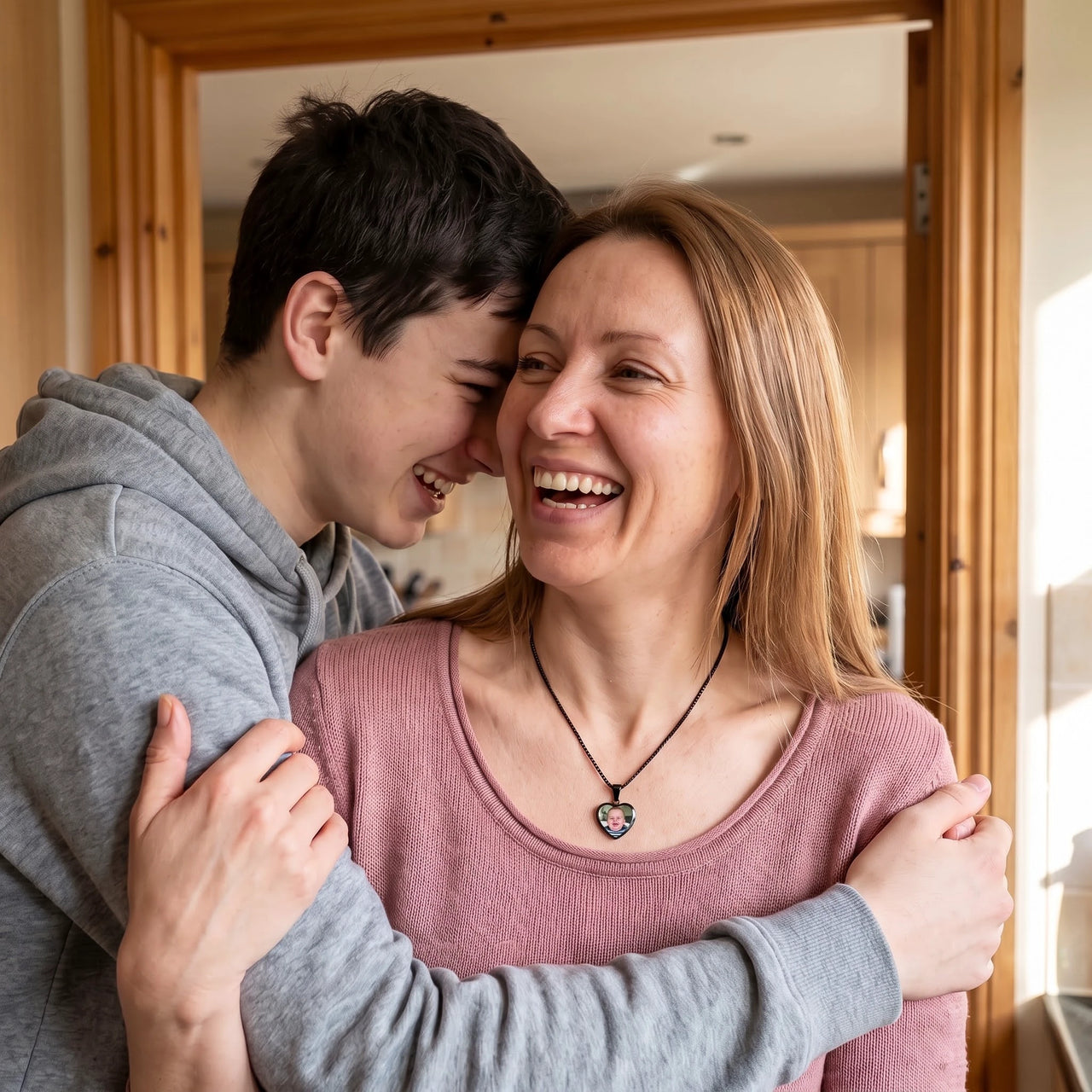 Mother hugging her son, wearing the black secret heart photo necklace | SKU: TPH-CHTN-BLACK-SMALL