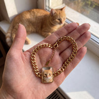 Thumbnail for Customer photo: the gold cushion-cut bracelet with her ginger cat's photo, her cat in the background | SKU: TPH-CUSB-GOLD
