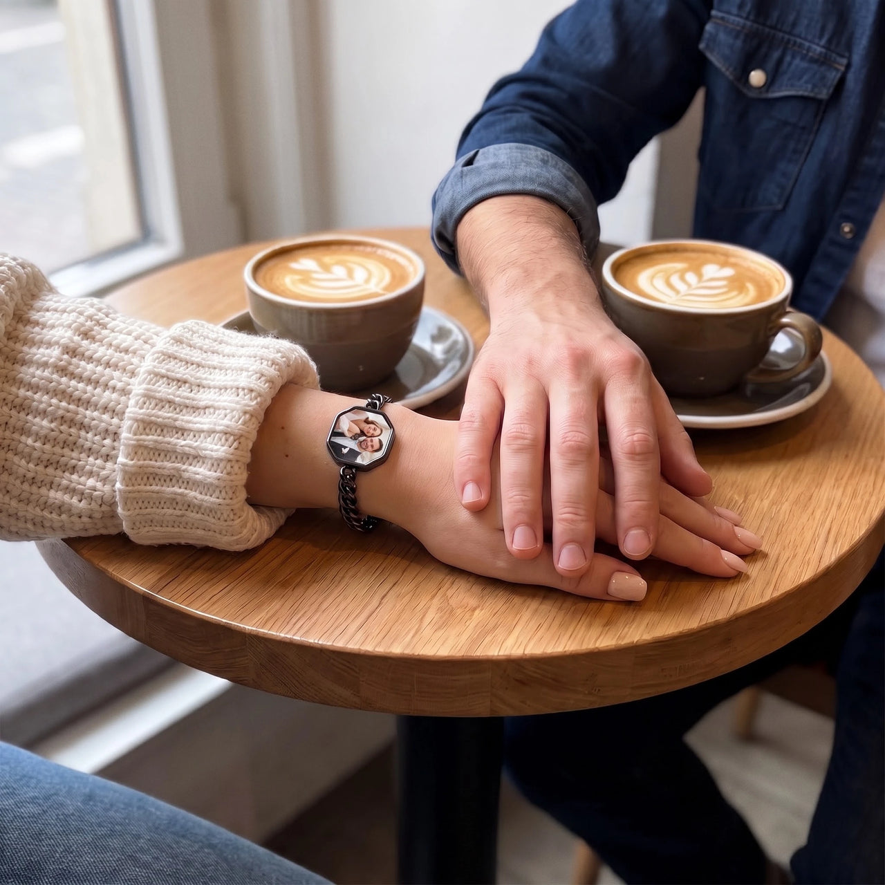 Couple holding hands at a cafe table, the black octagon photo bracelet on her wrist | SKU: TPH-OCTB-BLACK-18