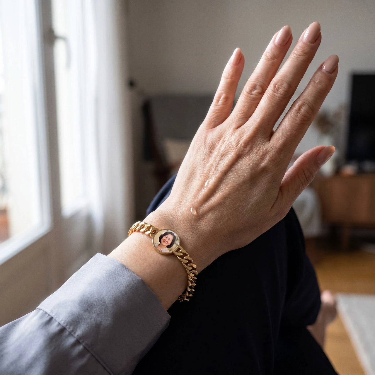 A tear on her hand as she looks at her mother's photo in the gold round photo bracelet | SKU: TPH-RNDB-GOLD