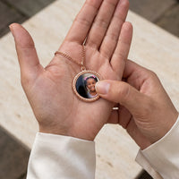 Thumbnail for Thumb warming the rose gold round pendant: the hidden photo appears under the thumb while the rest stays black | SKU: TPH-RNDN-ROSEGOLD