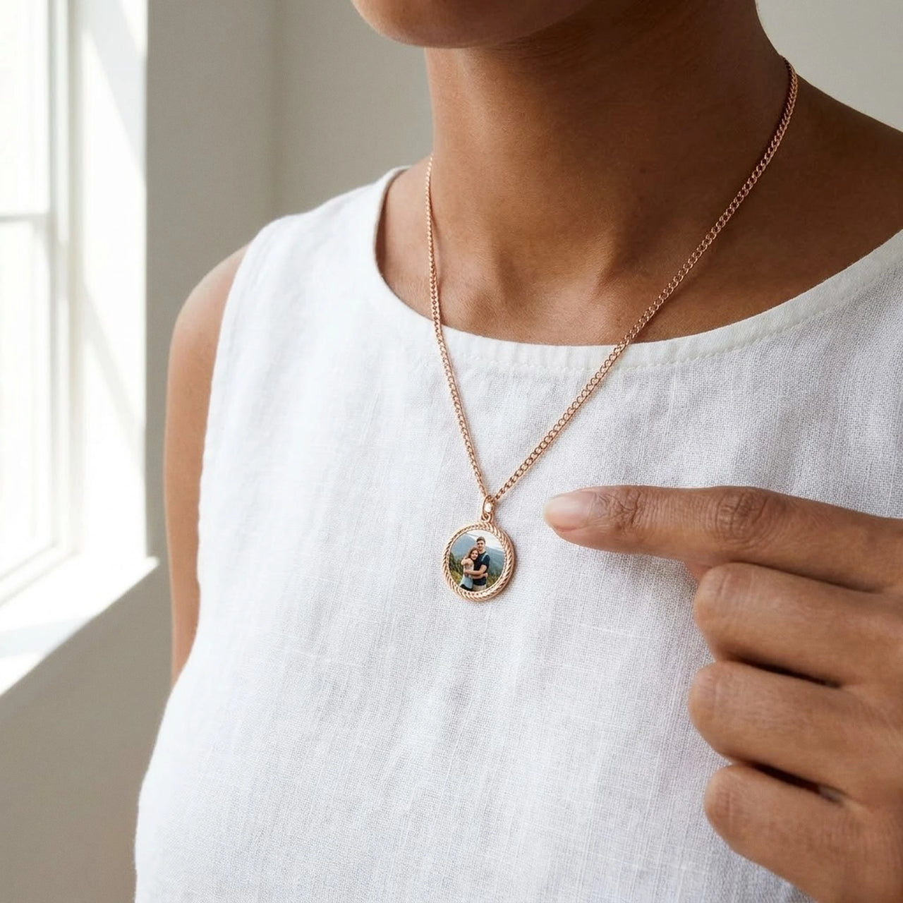 Looking down at the rose gold round pendant next to her fingertip, real small size, couple photo inside | SKU: TPH-RNDN-ROSEGOLD